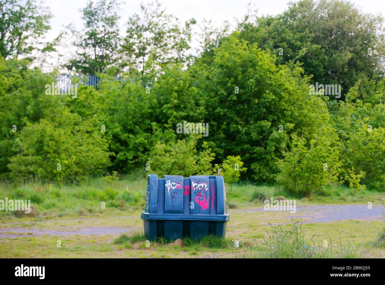 An abandoned oil tank sits on its own among scrub on wasteland in east Belfast, Northern Ireland. Stock Photo
