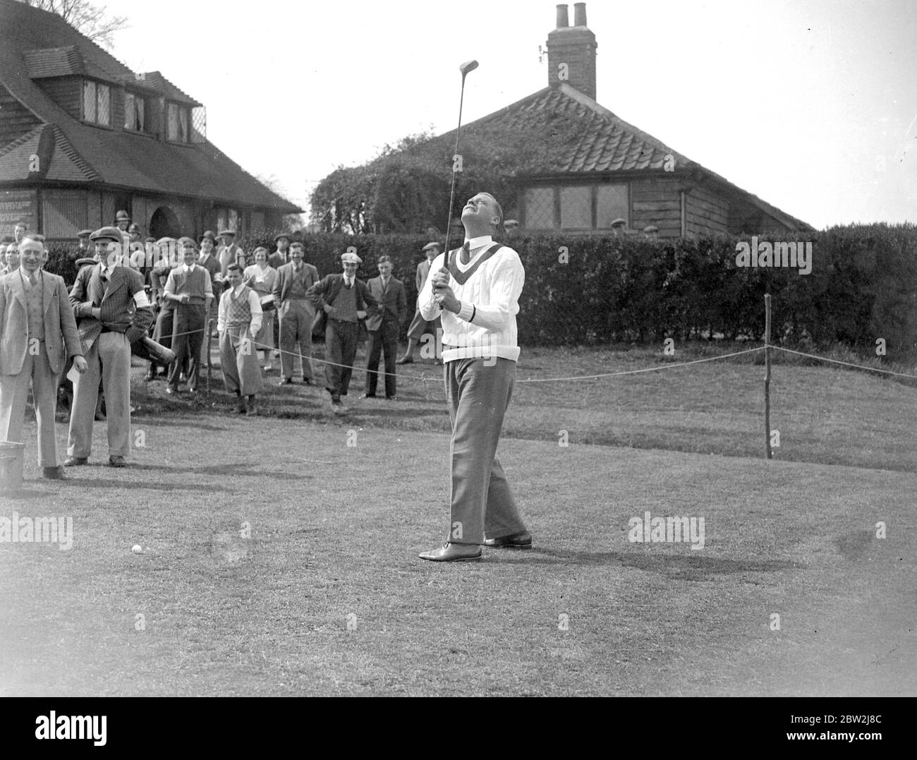 Australian cricket player, Bill Woodfull, playing golf in front of spectators. Stock Photo