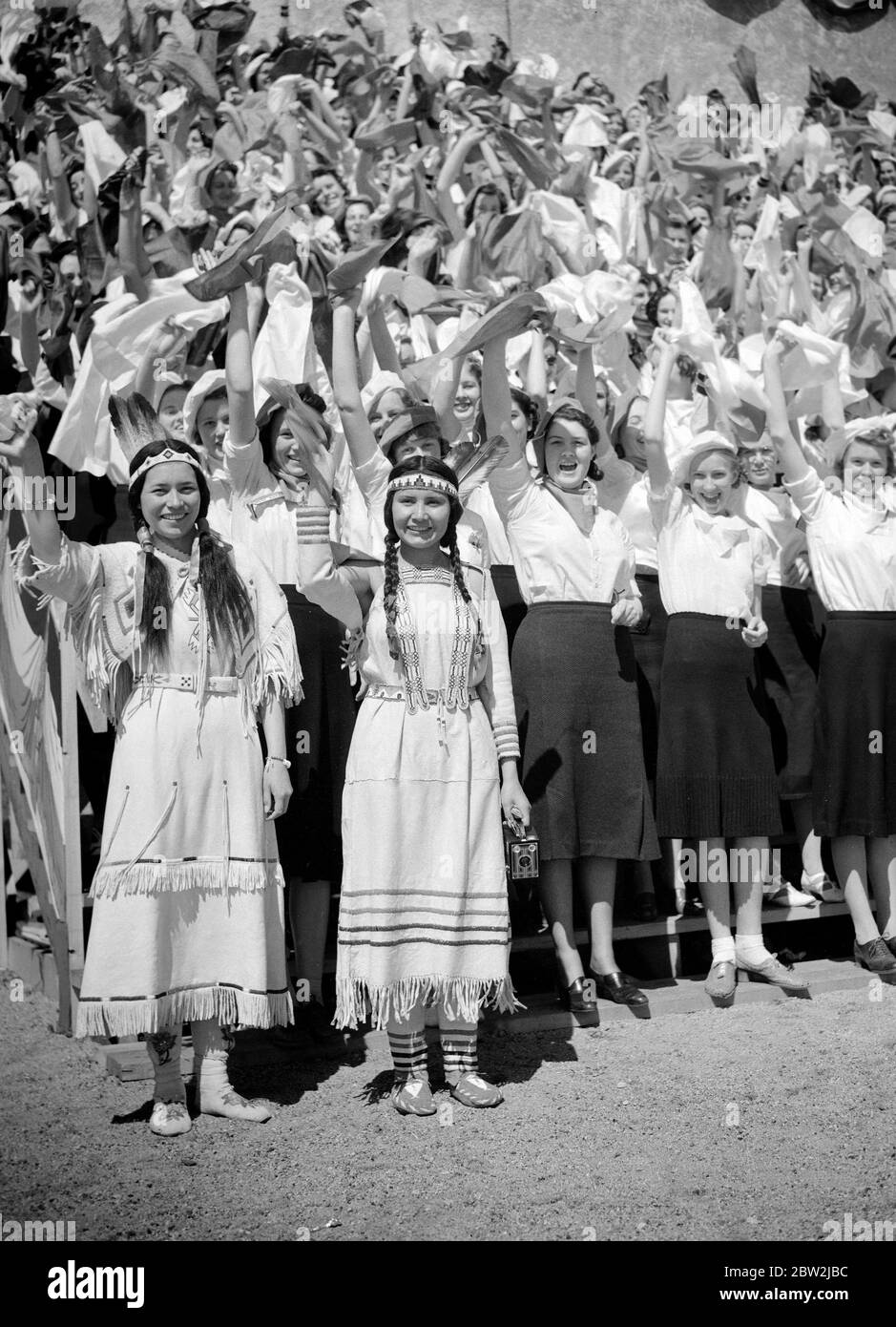 The King George VI and Queen Elizabeth on their Canadian tour of 1939 . The King and Queen's welcome at Saskatoon, Saskatchewan by Indian girl students Ninaki , a chief woman of the Blackfeet Indians ( on left ) and Weetchikoo a Cree Indian , among the crowds. Stock Photo