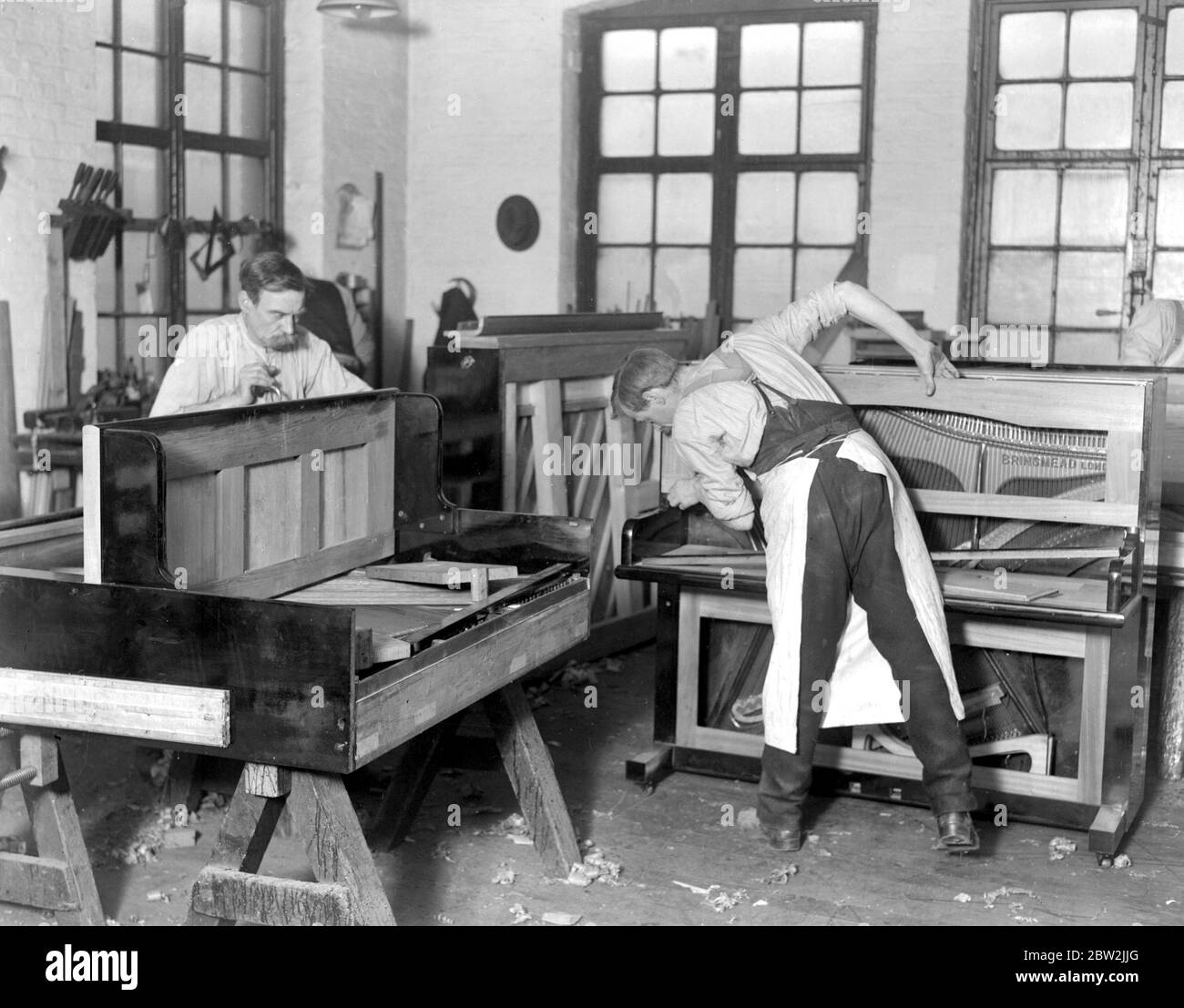 Piano making at Brinsmead's Factory . Finishing off the cases of an upright and a grand . [no date] Stock Photo
