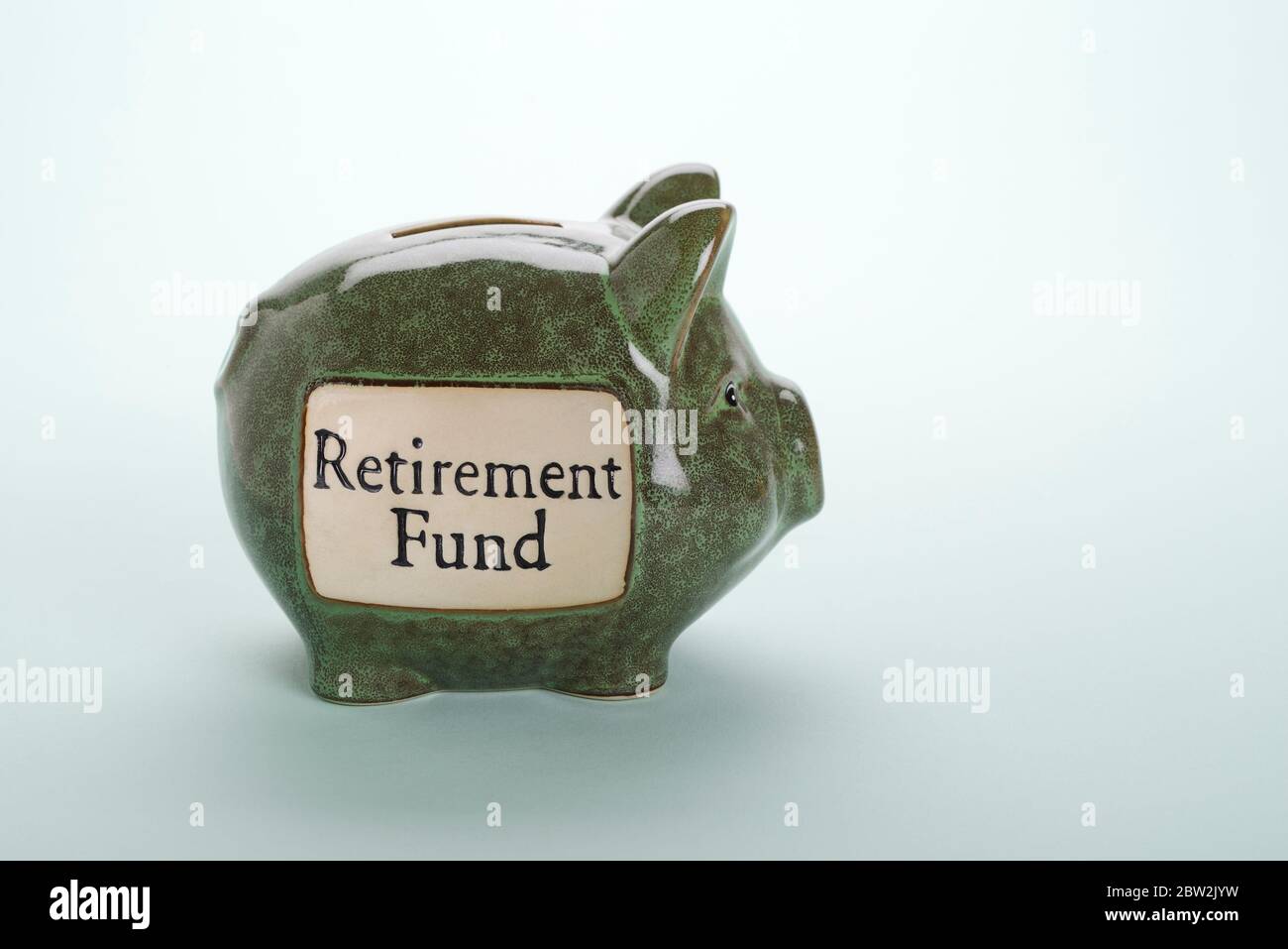A green piggy bank labelled retirement fund Stock Photo