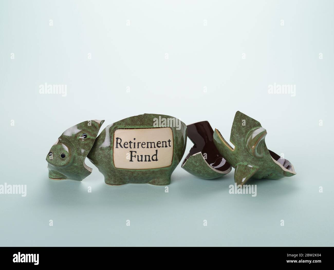 A broken piggy bank labelled retirement fund Stock Photo