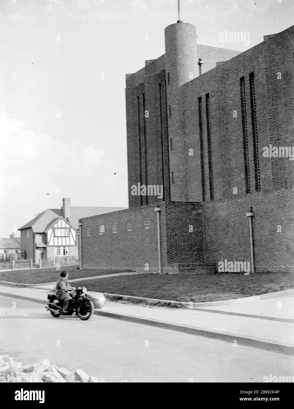 A motorcycle St Saviour Church, Eltham, Kent. 1934 Stock Photo