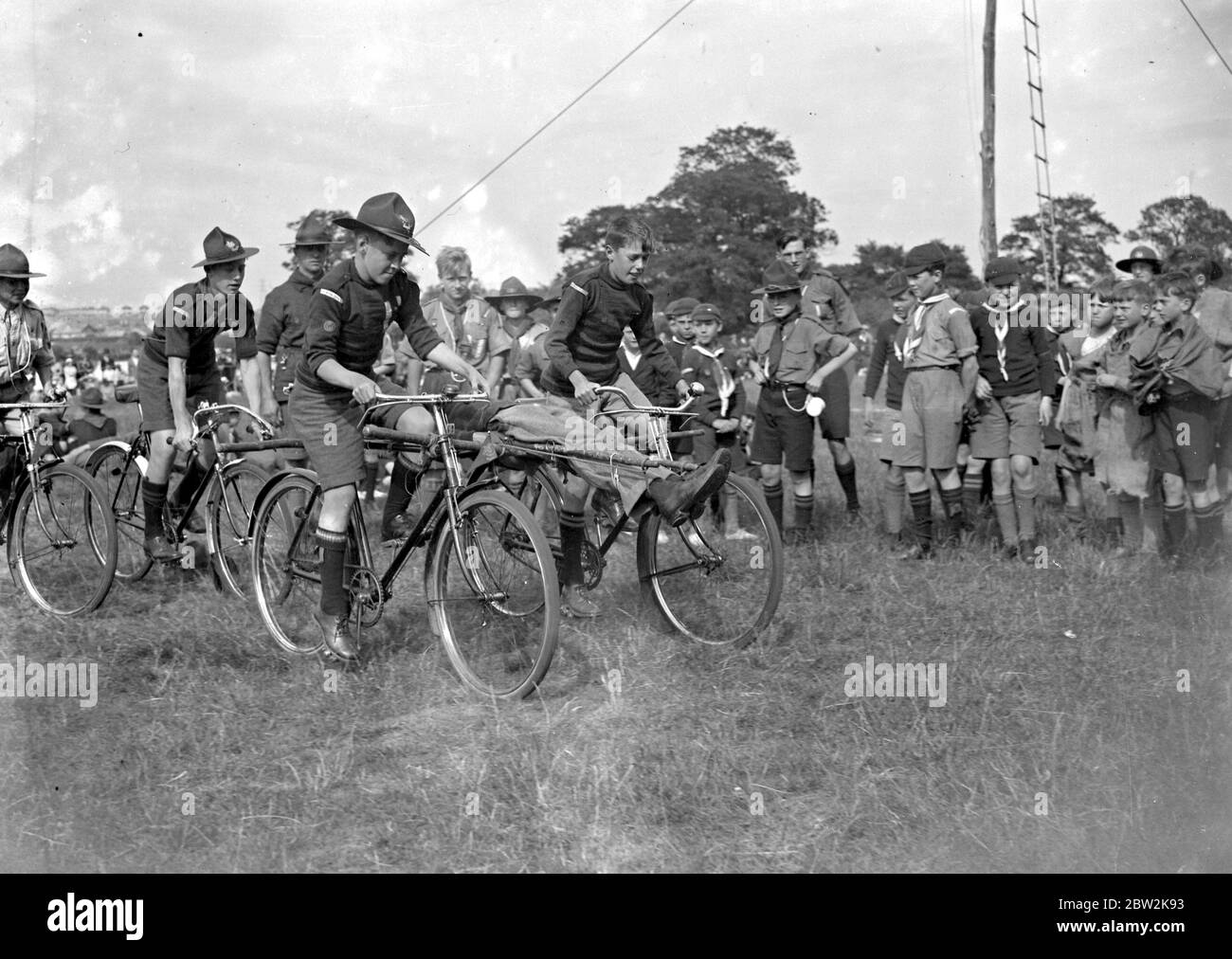 Scout display: cycling and injuired person. 1934 Stock Photo