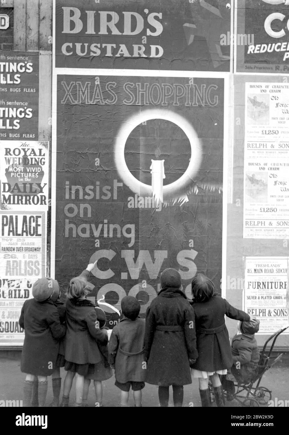 Children look up at a CWS poster. 1934 Stock Photo