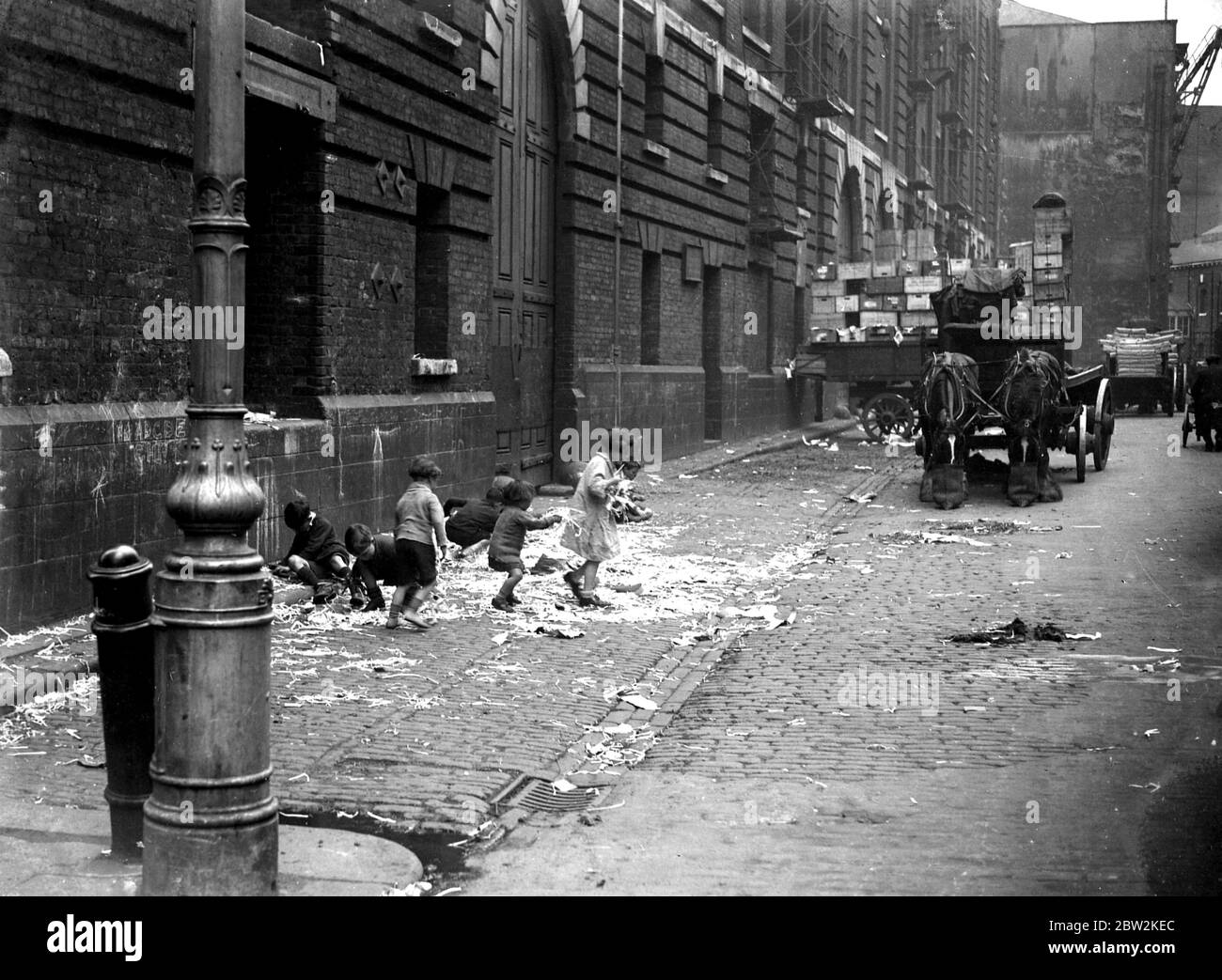 Toddlers & small chidren playing in the street by the docks in London. 1933 Stock Photo