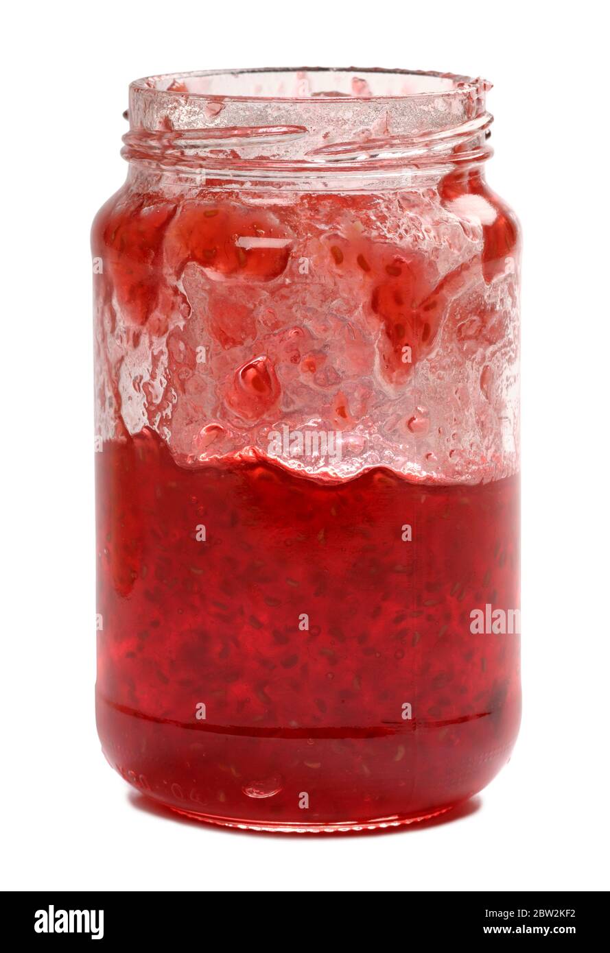 Half a jar of home made raspberry jam Stock Photo