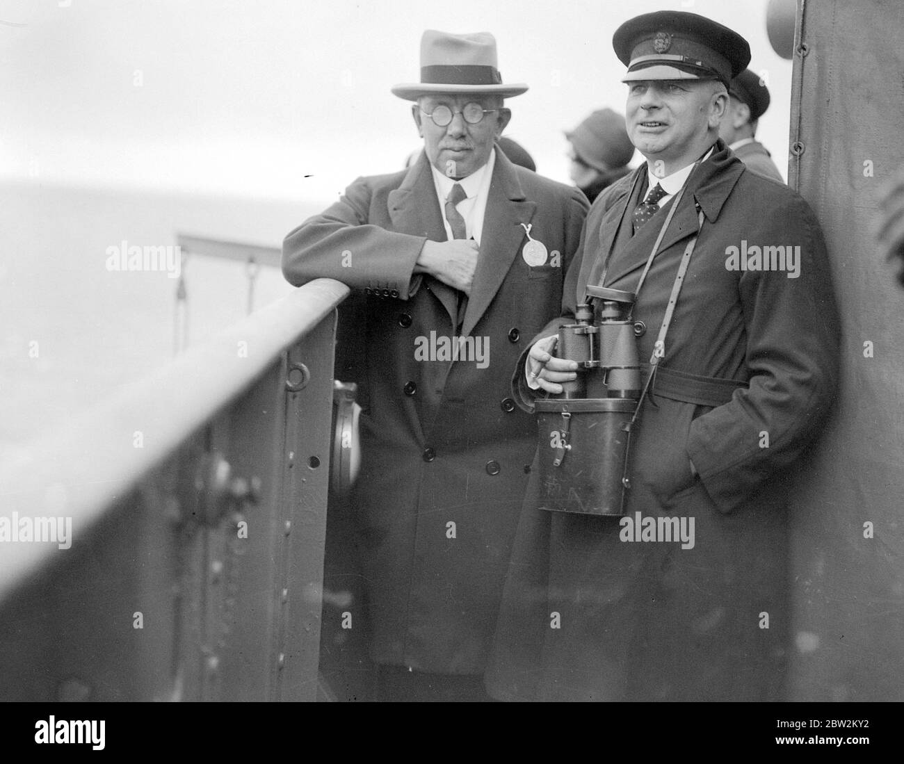 Premiers Day with the fleet at sea on board The Nelson. RE. Hon. J.H. Thomas and the 1st Lord of the Admirality viewing the exercises from the search platform. 1930 Stock Photo