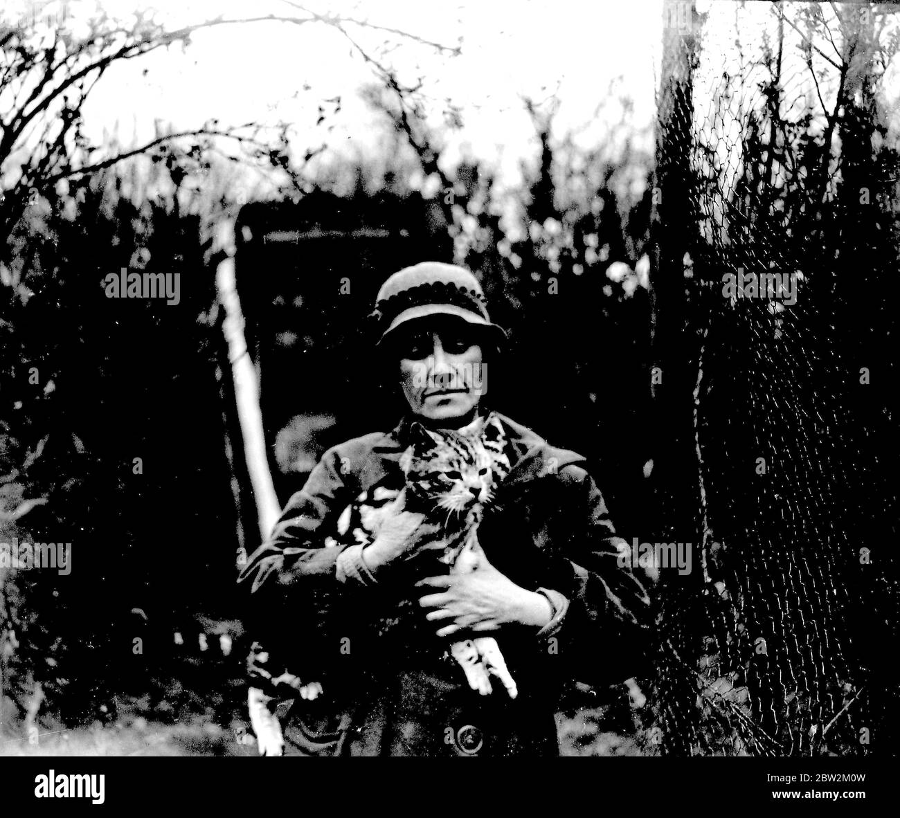 Miss Nancy Rutherford holding one of her many cats. (Otford) 1934 Stock ...