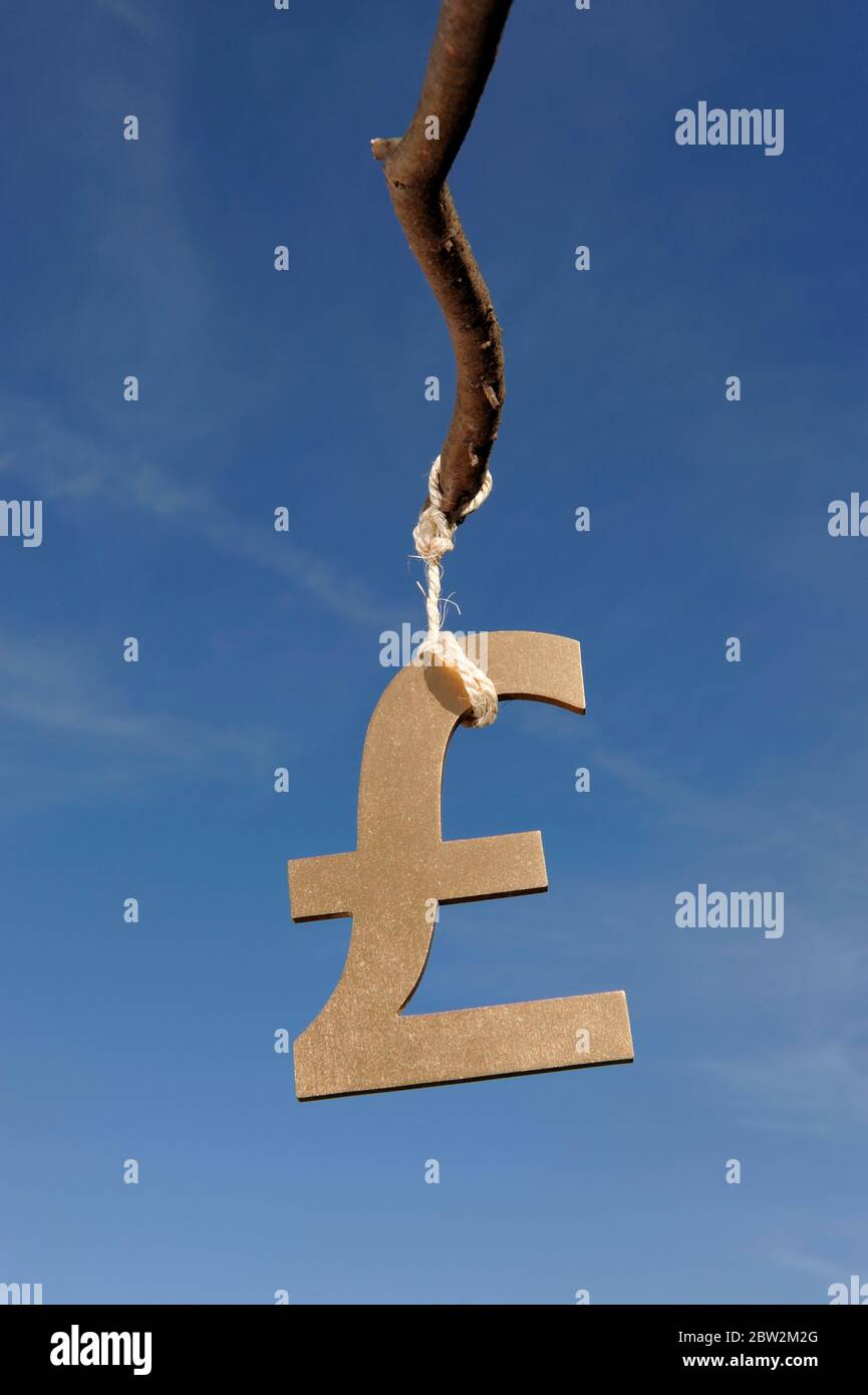 A pound sterling symbol hanging from a stick Stock Photo