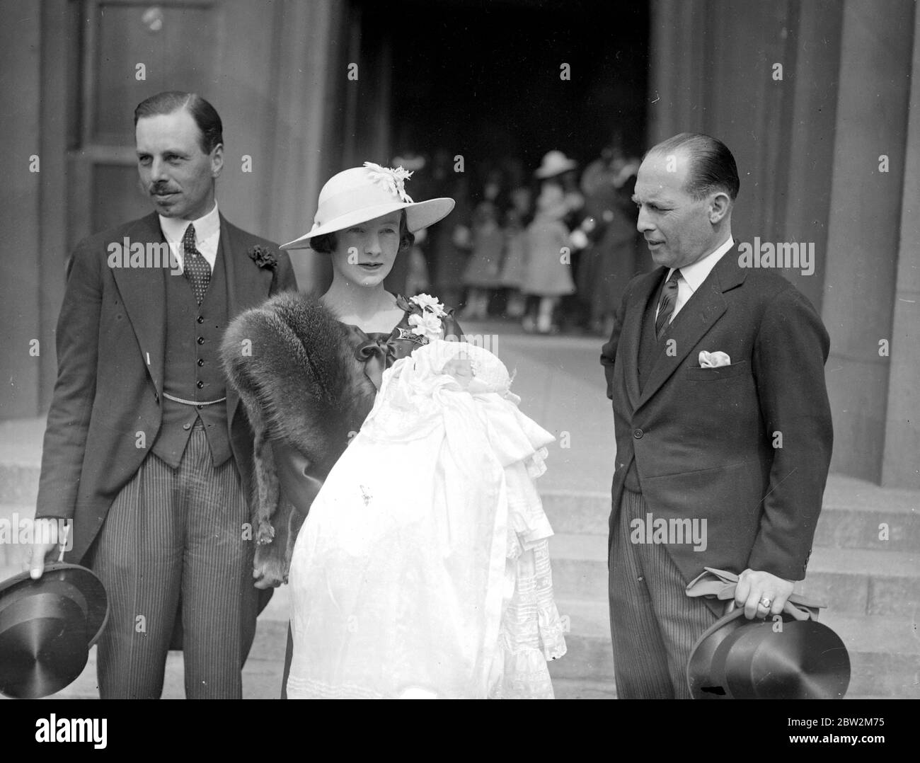 Major Sir Alexander and Lady Stanier with their infant son Beville Dougloas, after the christening of the latter at Wellington Barracks, London. 29 May 1934 Stock Photo