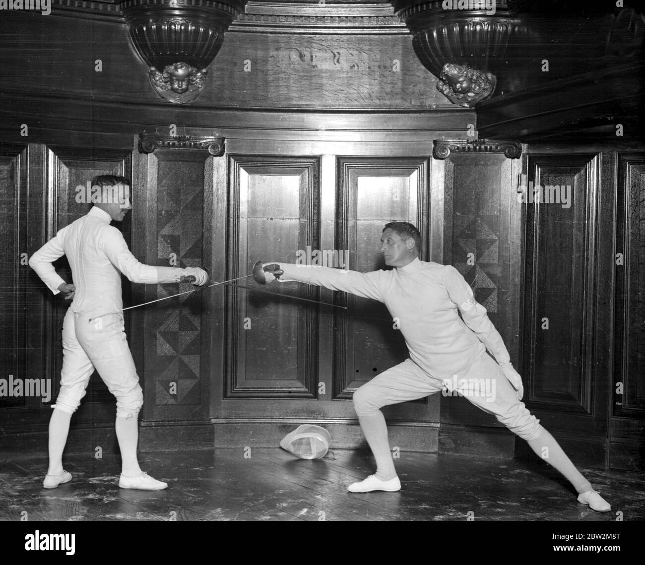 Fencing display at the Aeolian Hall arranged by Professor Felix Grave. Professor Desire Baudat and M. Hostalier.. undated Stock Photo