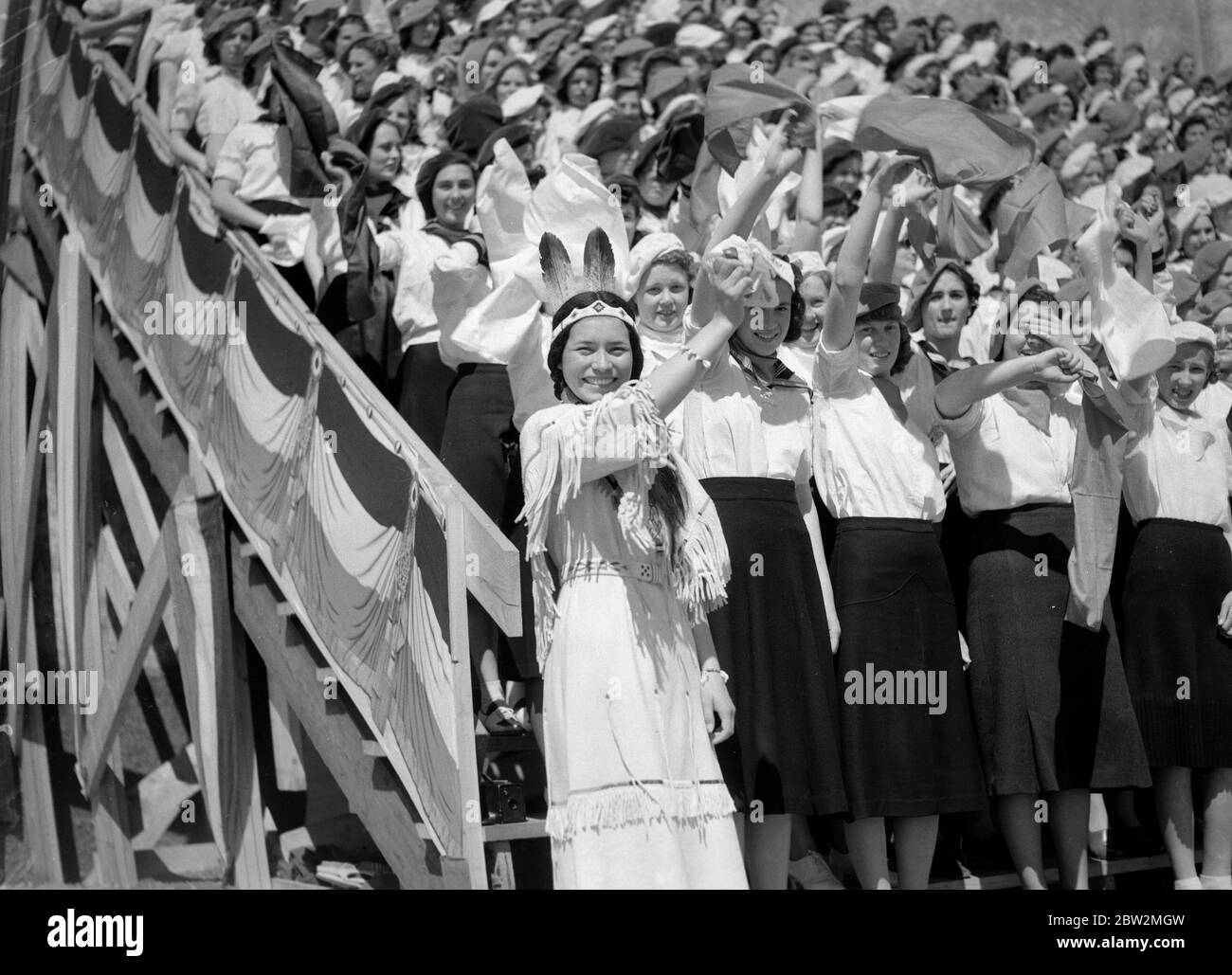 King George VI and Queen Elizabeth on their Canadian tour of 1939 . The King and Queen's welcome at Saskatoon, Saskatchewan by Indian girl students Ninaki , a Chief Woman of the Blackfeet Indians among the crowds. Stock Photo