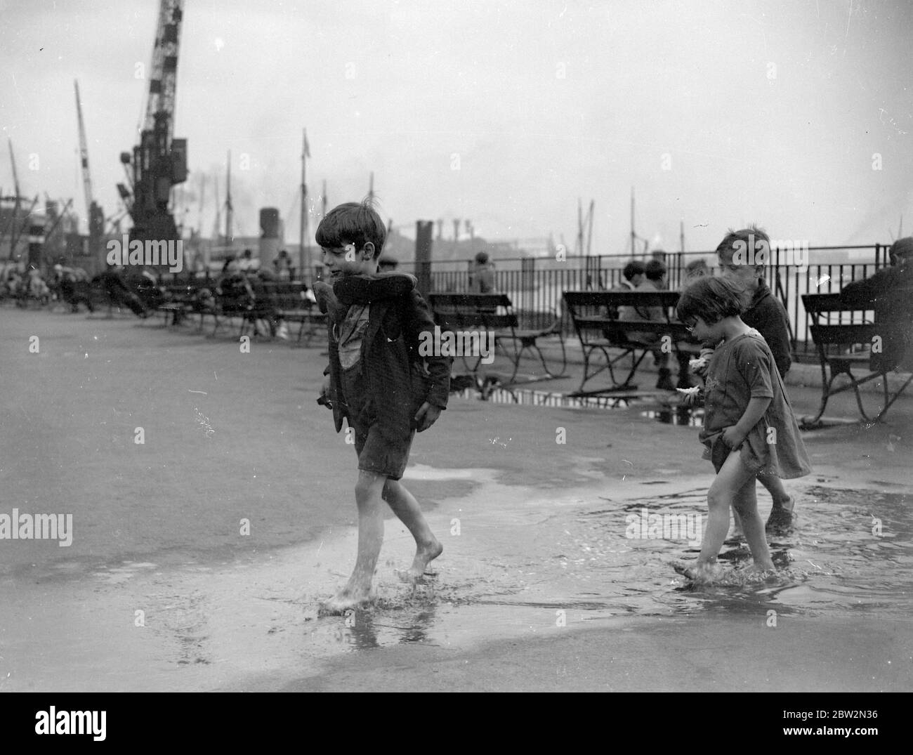 Children playing in Wapping Park paddling pool, London. 1933 Stock