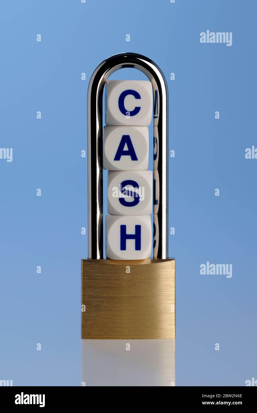 The word cash enclosed within a brass padlock Stock Photo