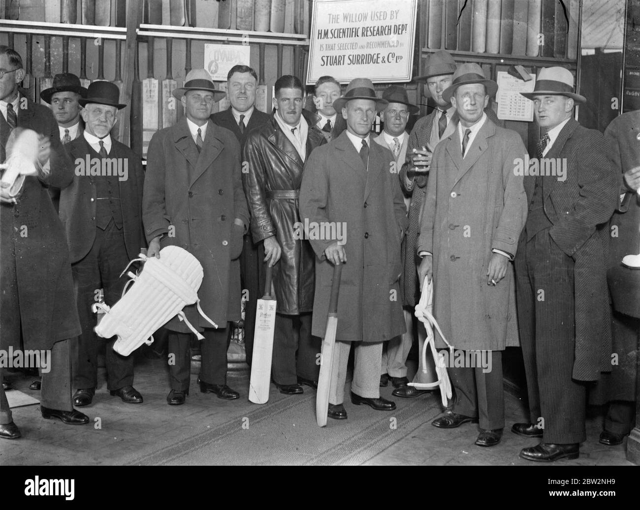 The Australian Ashes touring team buys their gear from at London sports outfitters . The tourists were captained by Bill Woodfull, . Photo shows the team photographed at the store . 26 April 1934 . Stock Photo