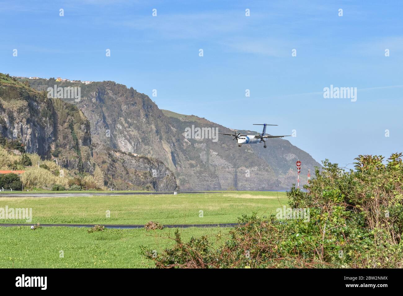 SATA propellor driven plane lands approaches from the sea and lands at Flores airport, Flores, Azores Stock Photo