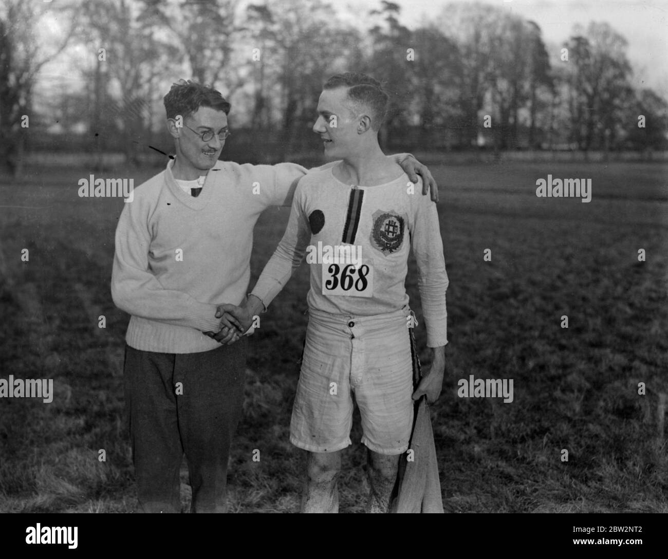 Winner of Southern Counties cross country championship . Fifty seven teams comprising an entry of over five hundred runners , competed in the Southern Counties Cross Country championship at Beaconsfield, Bucks . L H Weatherill ( left ) the winner being congratulated by his clubmate L F Humphries both of South London Harriers who was second . 27 February 1932 30s, 30's, 1930s, 1930's, thirties, nineteen thirties Stock Photo