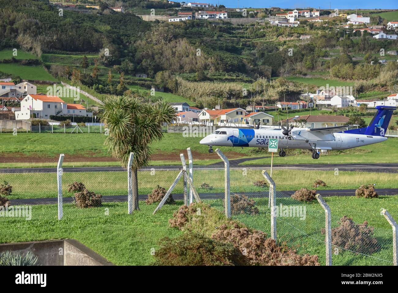 SATA propellor driven plane lands approaches from the sea and lands at Flores airport, Flores, Azores Stock Photo
