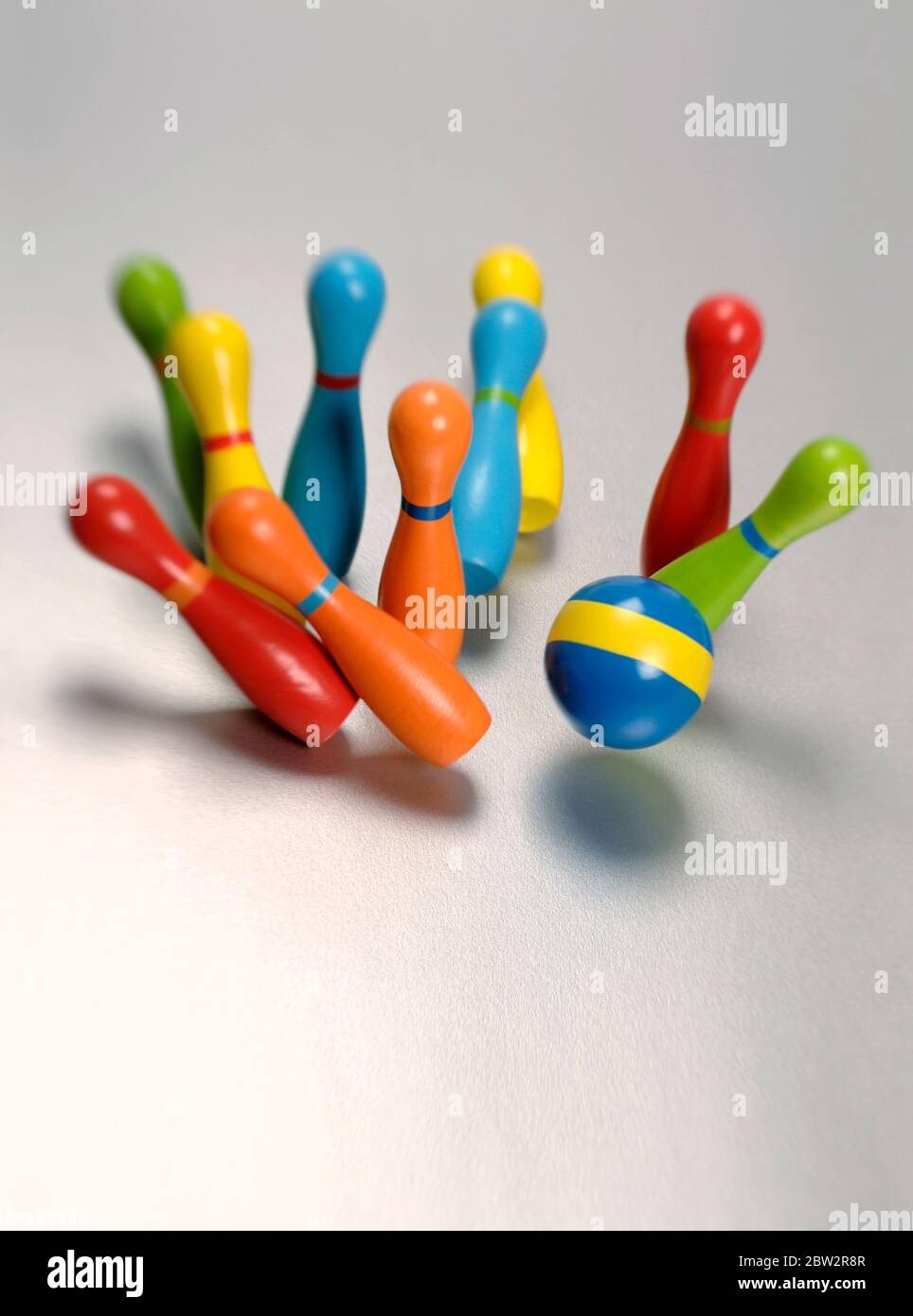 Toy bowling skittles being knocked over Stock Photo