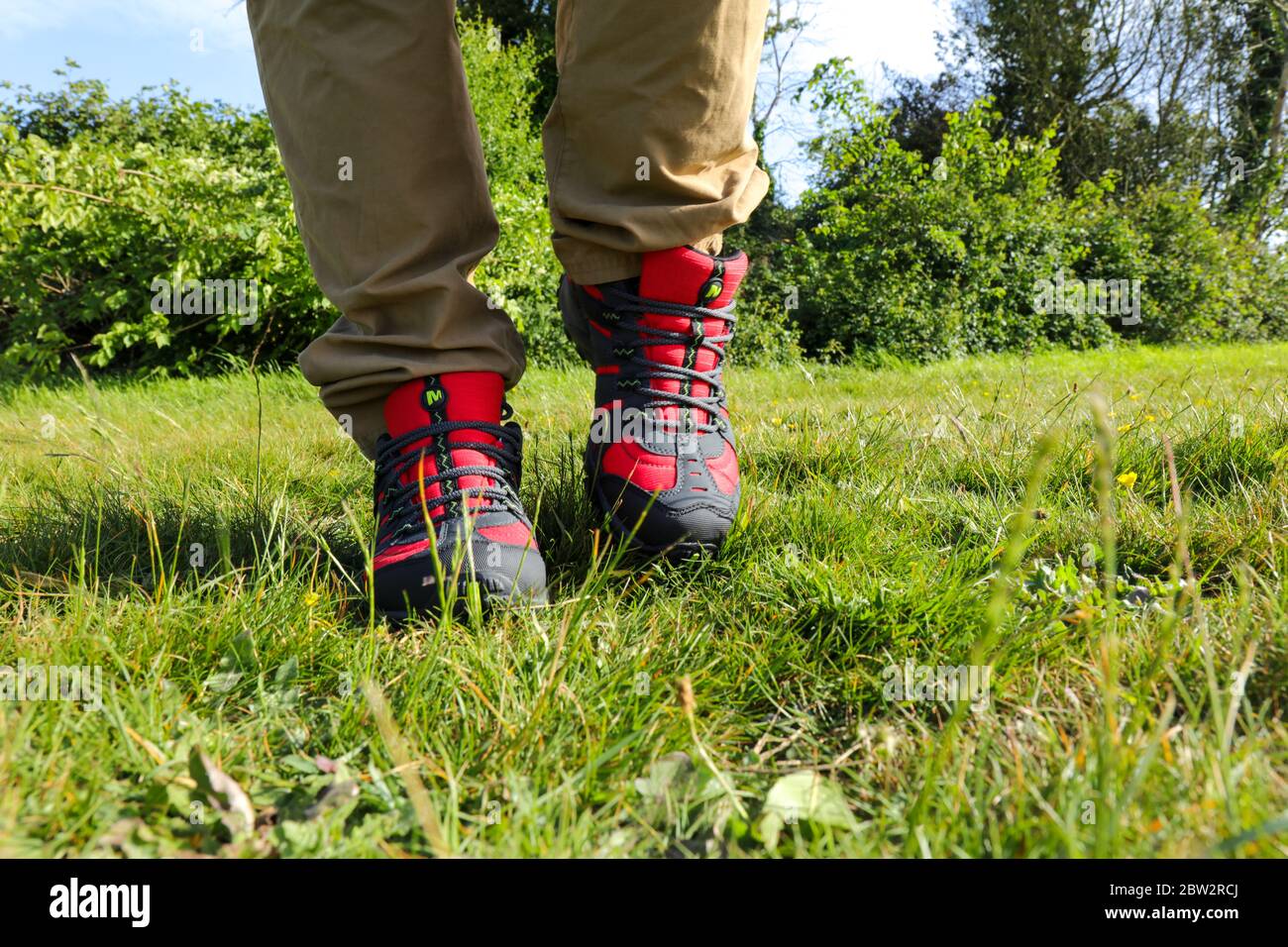 Man legs walking outdoor with a pair of Merrell Red Accentor Sport GORE-TEX  Trail Shoes Stock Photo - Alamy