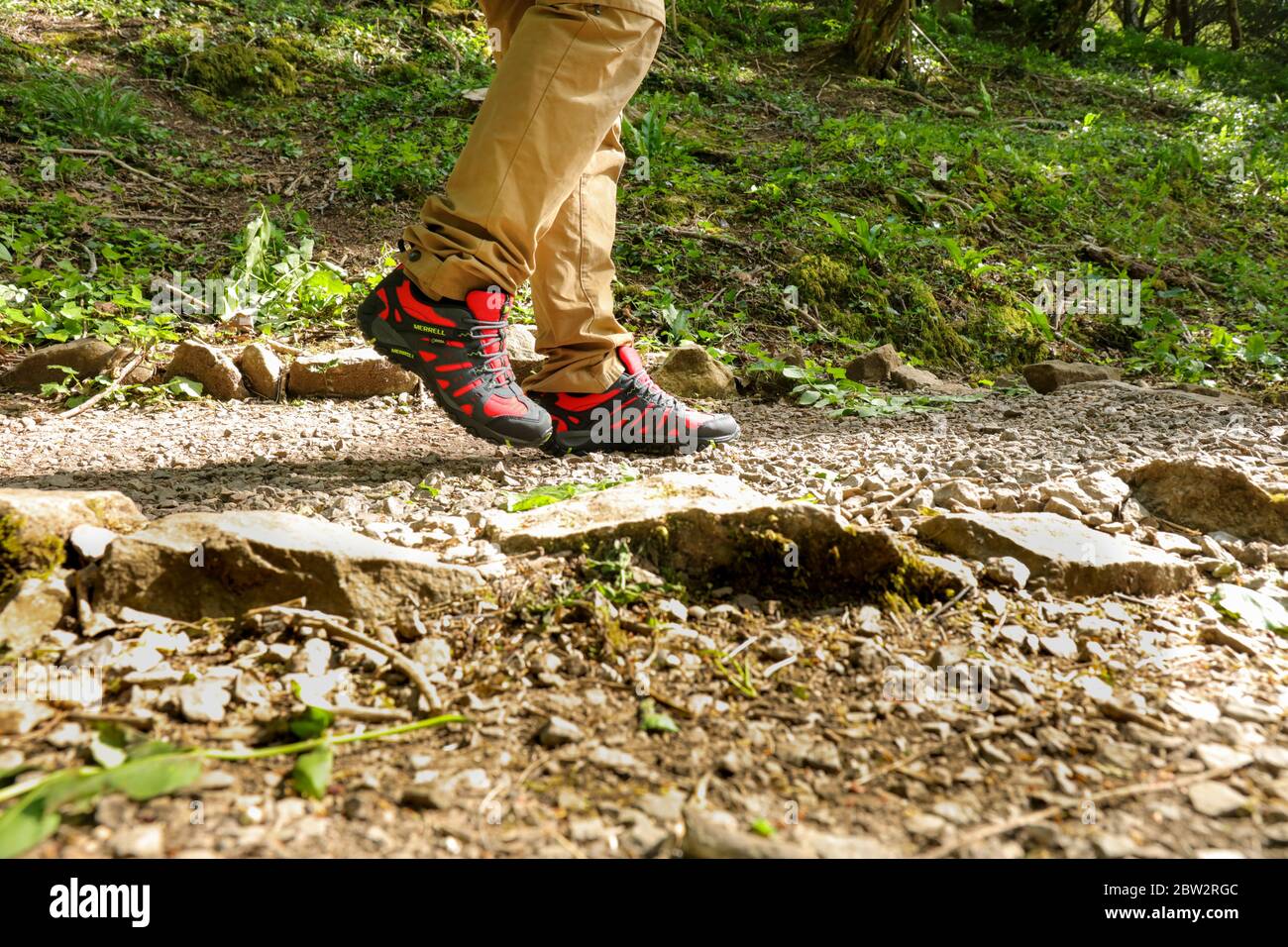 Man legs walking outdoor with a pair of Merrell Red Accentor Sport GORE-TEX  Trail Shoes Stock Photo - Alamy