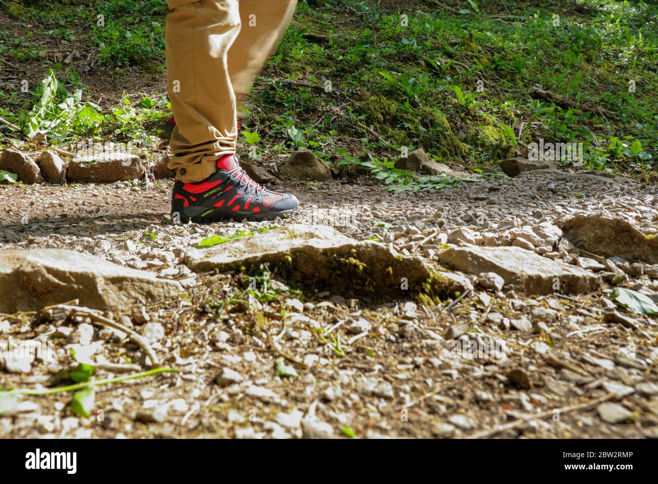 Man legs walking outdoor with a pair of Merrell Red Accentor Sport GORE-TEX  Trail Shoes Stock Photo - Alamy