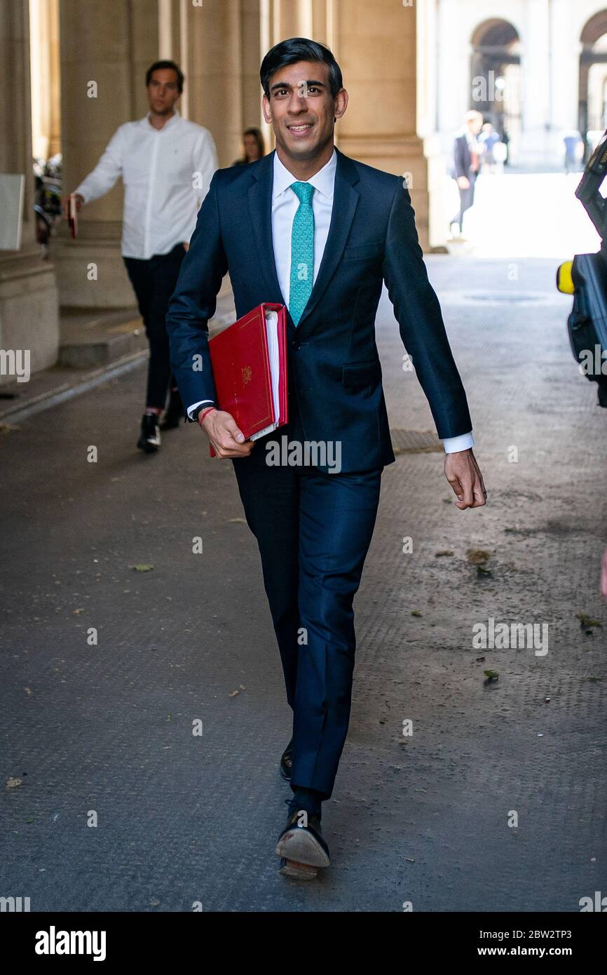 Chancellor of the Exchequer Rishi Sunak walks through from the foreign office to Downing Street after the introduction of measures to bring the country out of lockdown. Stock Photo