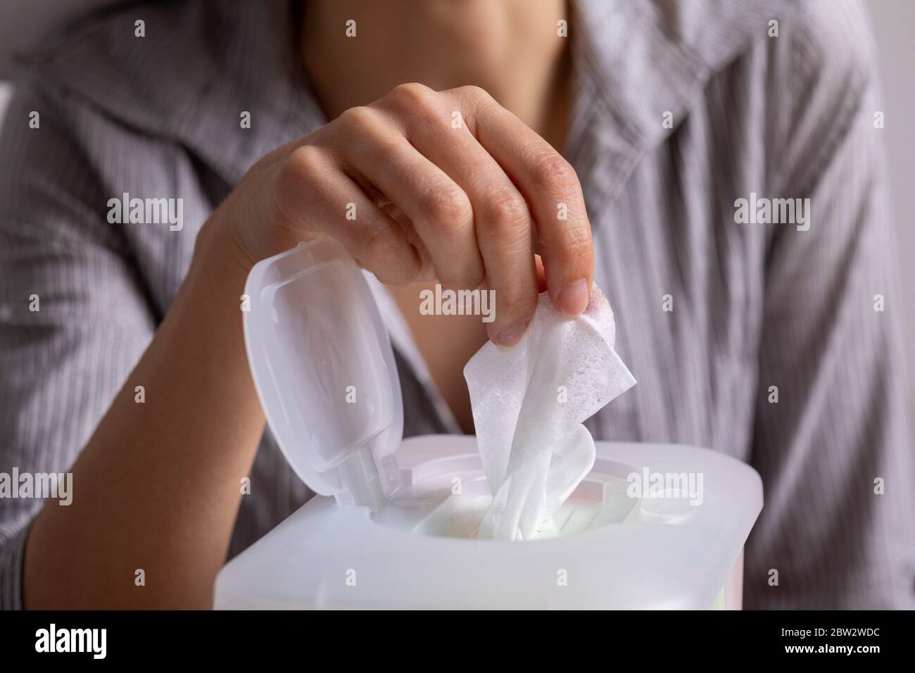 Wet wipes are universal an practical woman hand take one wipe from big