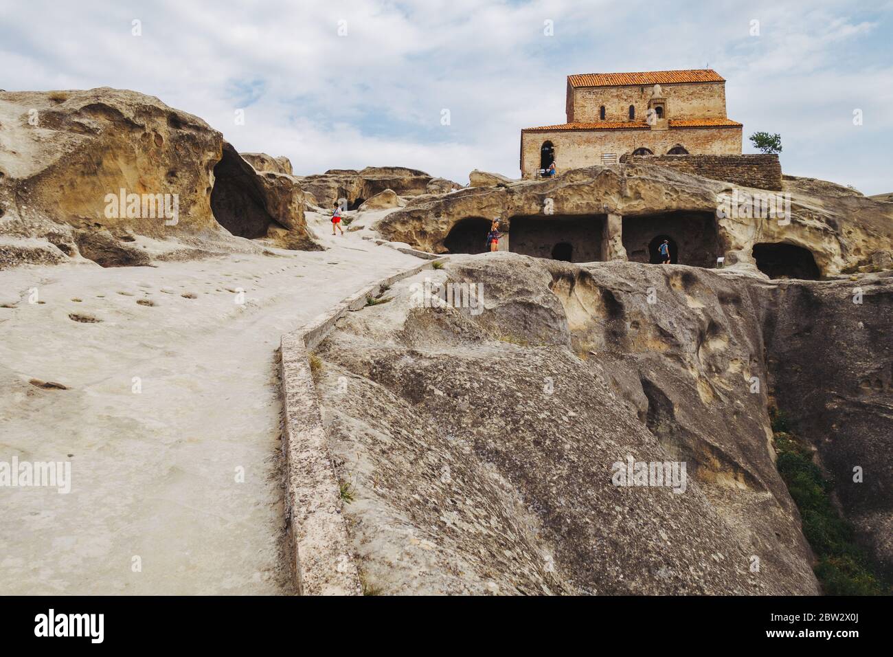 Rock-cut buildings and a new church in Uplistsikhe, an ancient town said to be one of Georgia's oldest settlements Stock Photo