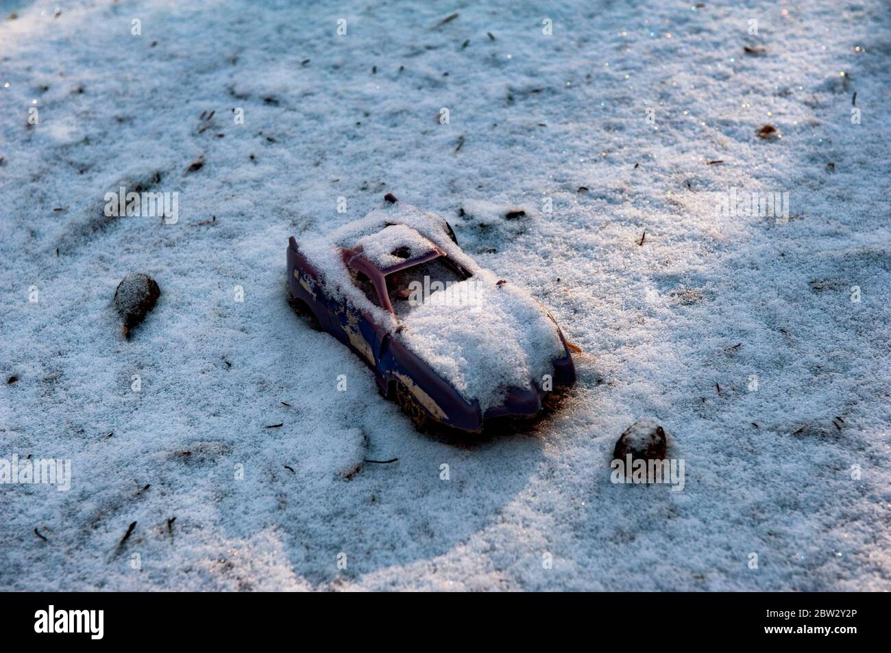Abandoned or lost toy lies on the snow. Concept of loneliness, depression and death Stock Photo
