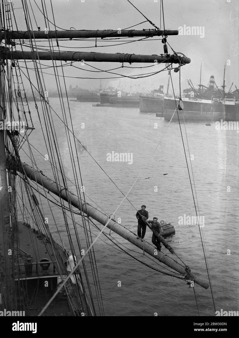 Last grain windjammer arrives in London . The last arrival of the windjammer grain fleet from Australia , the full rigged Finnish ship Grace Harwar , arrived at Victoria Docks , London , after a voyage of 143 days . Members of the crew in the yard arms of the rigging at Victoria Docks on arrival . 22 September 1932 Stock Photo