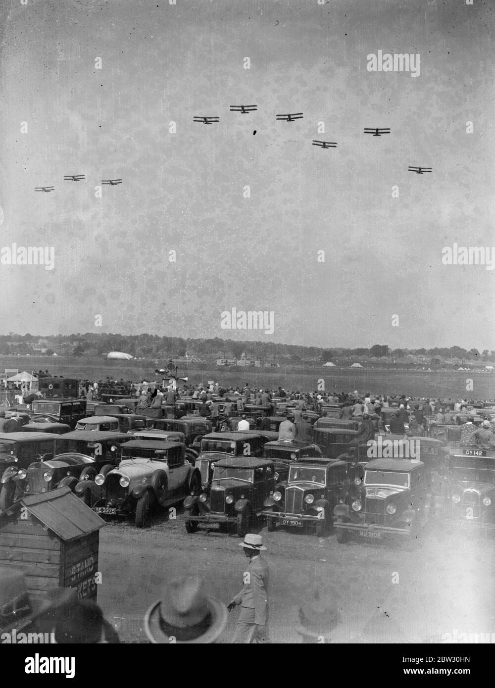 Enormous crowd watches thrilling air display at Hendon Air Pageant . An enormous crowd watched thrilling display of flying and aerial acrobatics at the Hendon Air Pageant , by the Royal Air Force , at Hendon Aerodrome , London . Planes flying over the crowd at Hendon . 25 June 1932 Stock Photo