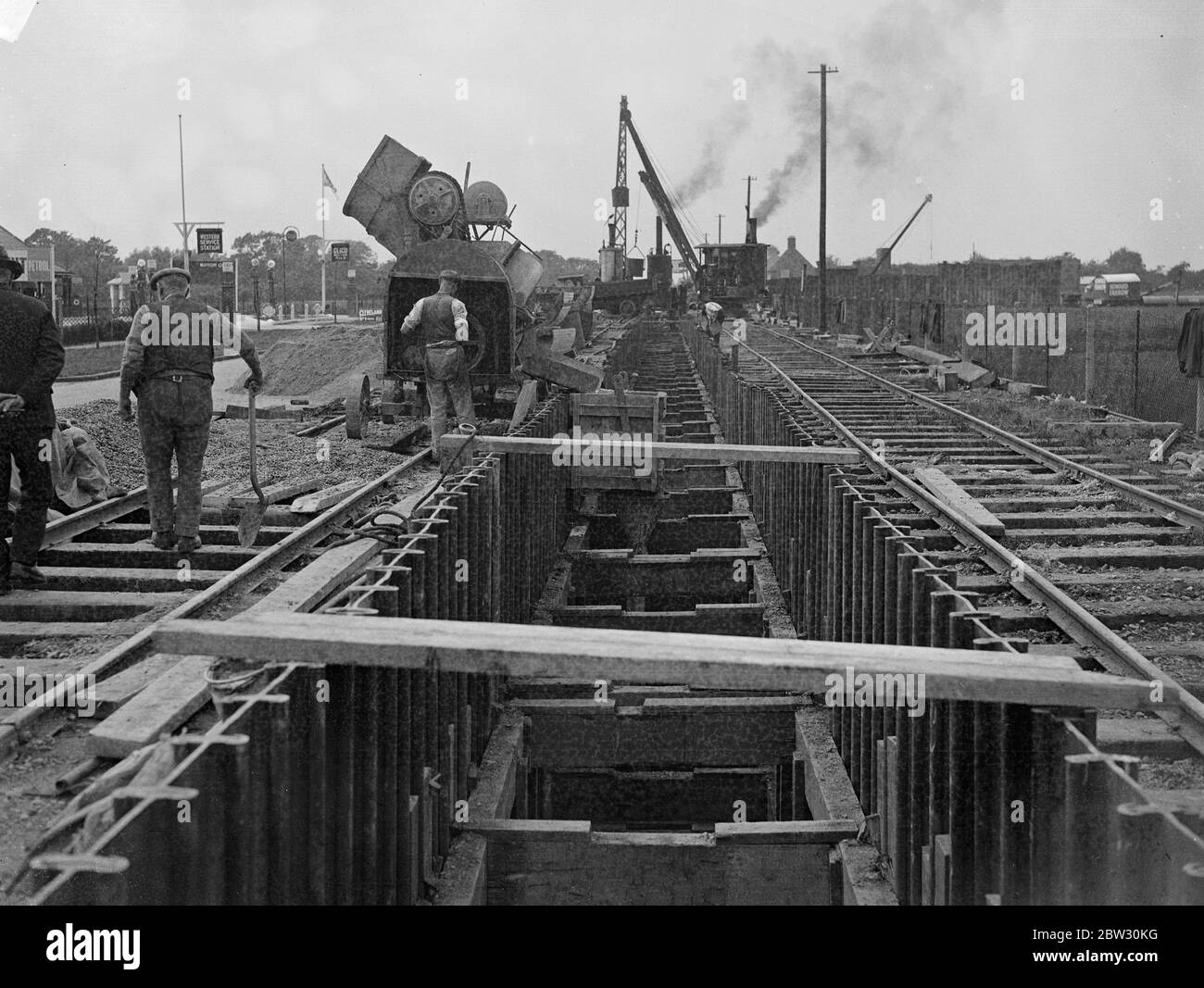 Twelve an half mile tunnel constructed beneath Colinbrook by pass . A tunnel twelve and a half miles long under the Colinbrook , Bucks , bypass road , is being constructed for the Middlesex County COuncil in which a nine foot sewer is being laid beneath the roadway . Men at work on the miles long tunnel for the sewer at Colinbrook by pass . 3 August 1932 Stock Photo