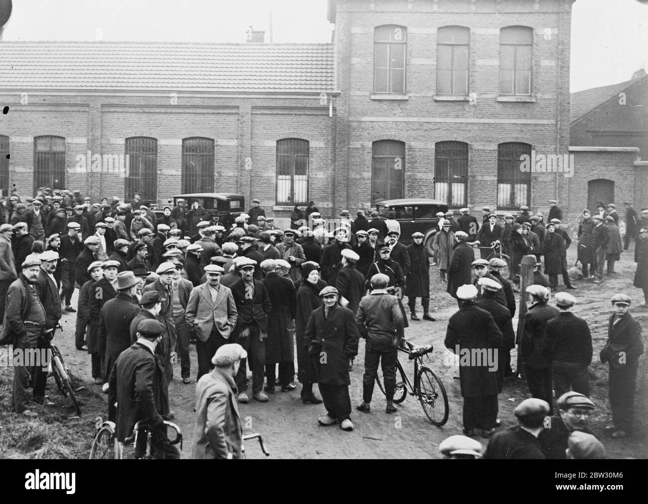 Sixteen dead in Belgian mine disaster . Sixteen miners lost their lives and seven were seriously injured , when they were entomed in the mine . They visited the stricken homes of the families of the dead miners . Crowds waiting for the latest news of the entombed miners outside the mine entrance . 9 February 1932 Stock Photo
