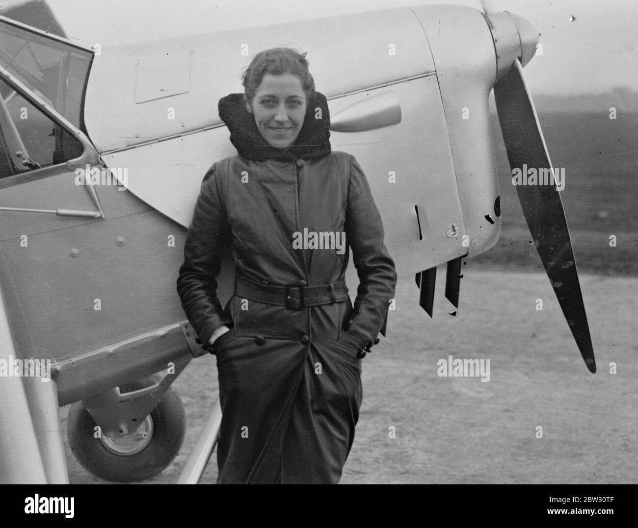 AMy Johnson ( Mrs Mollison ) leaves Stag Lane on first hop of her record flight to the cape . Mrs Mollison , the former Miss Amy Johnson , took off from Stag Lane aerodrome , near London , on the first stage of her record breaking flight to Cape Town in an effort to beat the record set up by her husband . The actual flight will start from Lympne . Mr J A Mollison accompanied her in his plane ' The Heart ' s Content ' as fsar as Lympne . Mrrs Mollison with her topee and flying maps beside her plane at Stag Lane before the take off . 8 November 1932 Stock Photo