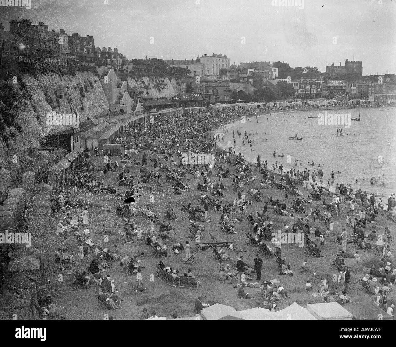 The king comes ashore at Cowes . Thousands of holidaymakers at Broadstairs enjoyed a perfect day on bank holiday . A view of the enormous crowd of holiday makers and bathers on the sands at Broadstairs on bank holiday . 1 August 1932 Stock Photo