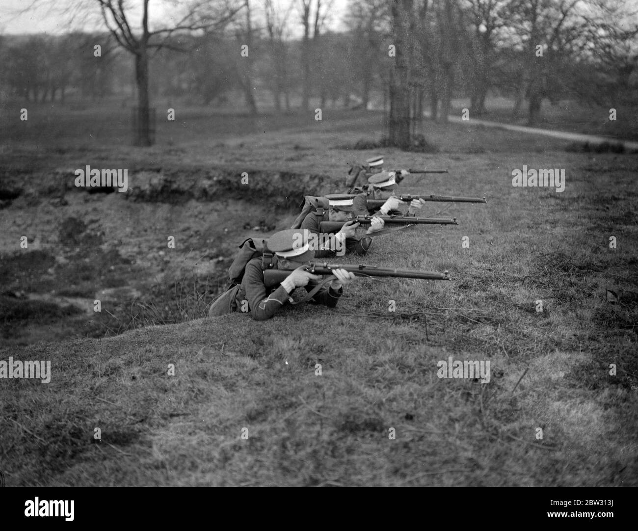 In the trenches at Windsor . Members of the Eton Officers Training Corps in the entrenchments in Windsor Park , a pit which made an ideal trench , during the College Field Day . 17 March 1932 Stock Photo