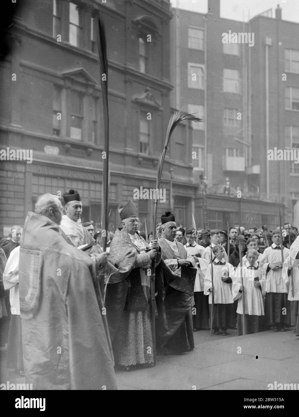 Cardinal Bourne heads Palm Sunday procession at Westminster Cathedral . Cardinal Bourne , head of the Roman Catholic church in England , headed the Palm Sunday procession to Westminster Cathedral , London . Cardinal Bourne blessing the palms at the ceremony outside the Cathedral . 20 March 1932 Stock Photo