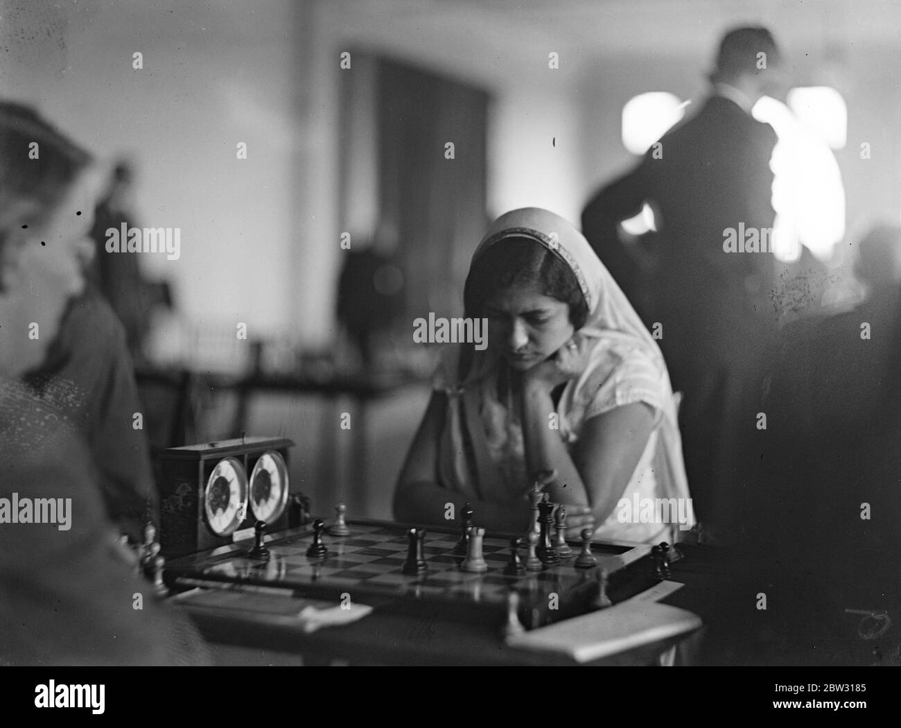 Indian girl concentrates in chess championship . Mrs Perin Mursah , an Indian girl who played in native sari , concentrating on a move during her match against Mr A J Duke in the British Chess Championship at the Empire Chess Club in London . 17 August 1932 Stock Photo