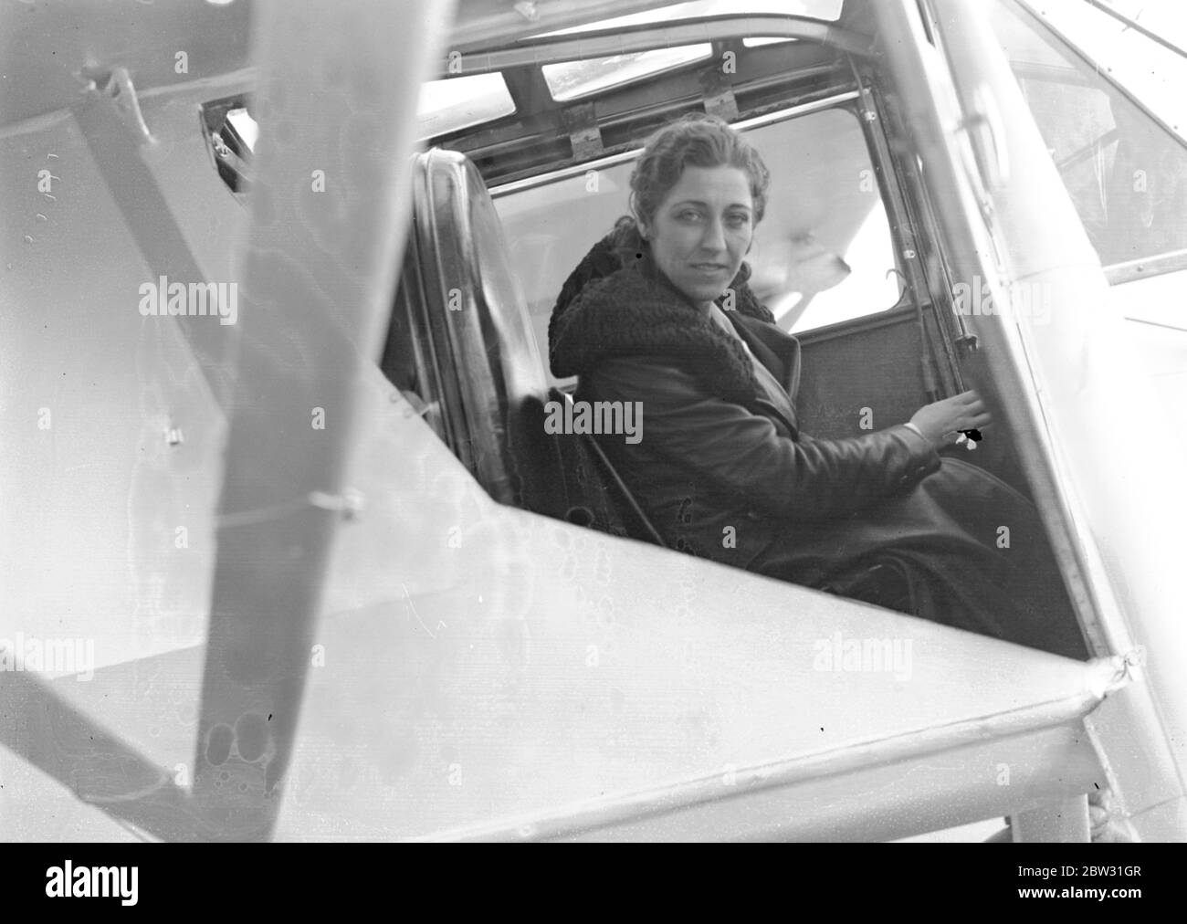 AMy Johnson ( Mrs Mollison ) leaves Stag Lane on first hop of her record flight to the cape . Mrs Mollison , the former Miss Amy Johnson , took off from Stag Lane aerodrome , near London , on the first stage of her record breaking flight to Cape Town in an effort to beat the record set up by her husband . The actual flight will start from Lympne . Mr J A Mollison accompanied her in his plane ' The Heart ' s Content ' as fsar as Lympne . Mrrs Mollison with her topee and flying maps beside her plane at Stag Lane before the take off . 8 November 1932 Stock Photo