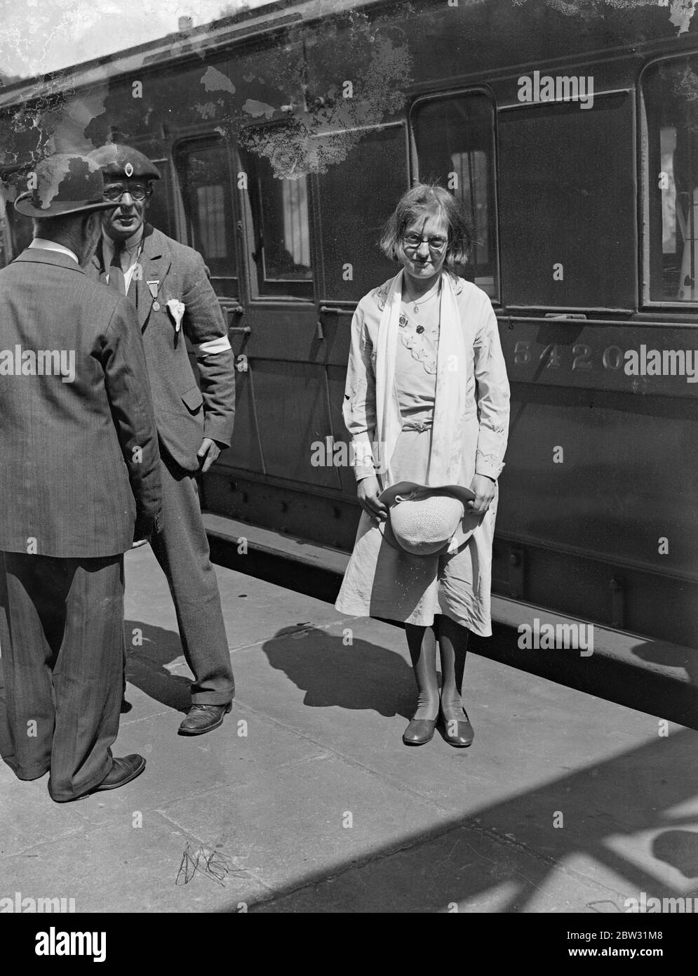 English girl has miraculous cure at Lourdes . Goes an invalid retuns home well . Miss Mary Kellett , the Salford , Manchester , girl , whose remarkable cure at the famous Lourdes Grotto this week caused so much excitement , travelled home as an ordinary passenger , seated in the train , instead of occupying a bunk as she did on the outward journey . Miss Kellett is 23 , for the past twenty months she has been prostrate with spinal trouble , and was taken to Lourdeson a stretcher . Miss Mary Kellett photographed in London on her way through in the train to her home in Manchester , after her vis Stock Photo