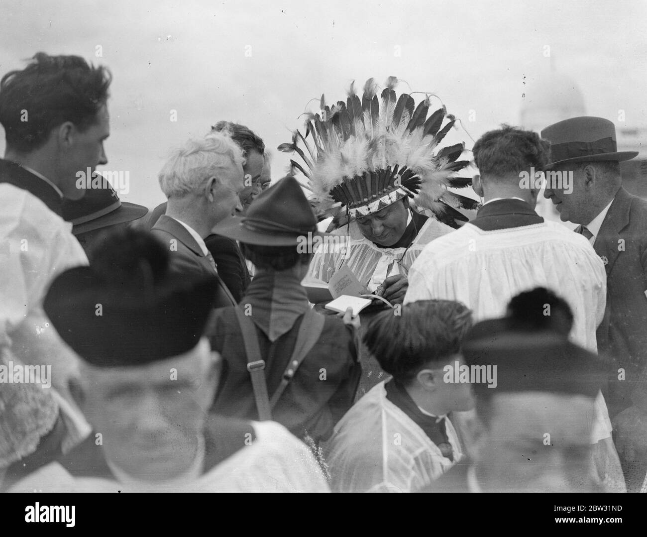 Million Catholics attend pontifical high mass at Eucharistic Congress in Phoenix Park , Dublin . More than a million people attended the Pontifical High Mass , conducted by Cardinal Laurie , the Papal Legate to the Eucharistic Congress , in Phoenix Park , Dublin . Father Philip Gordon , a North American Indian signing autographs at the mass . 26 June 1932 Stock Photo