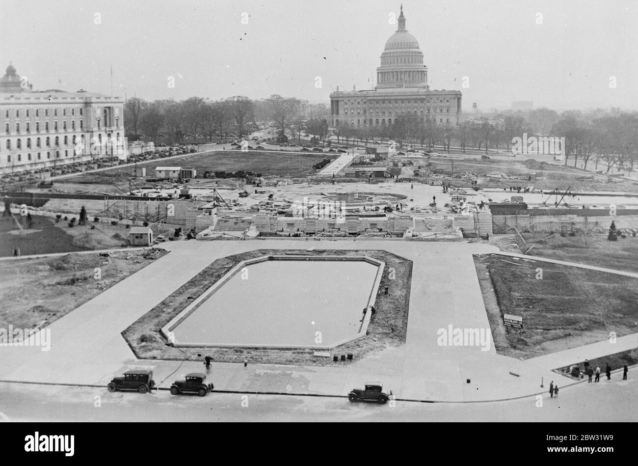 Changing face of America ' s capital . A terrace containing a fountain and undergroud garage is being built to the north of the capital in Washington DC . A view over the alterations showing the reflecting pool for the capitol Dome in the foreground , the fountain in the background is on top of the underground garage and is approached by steps which cover the street car subway . 2 March 1932 Stock Photo