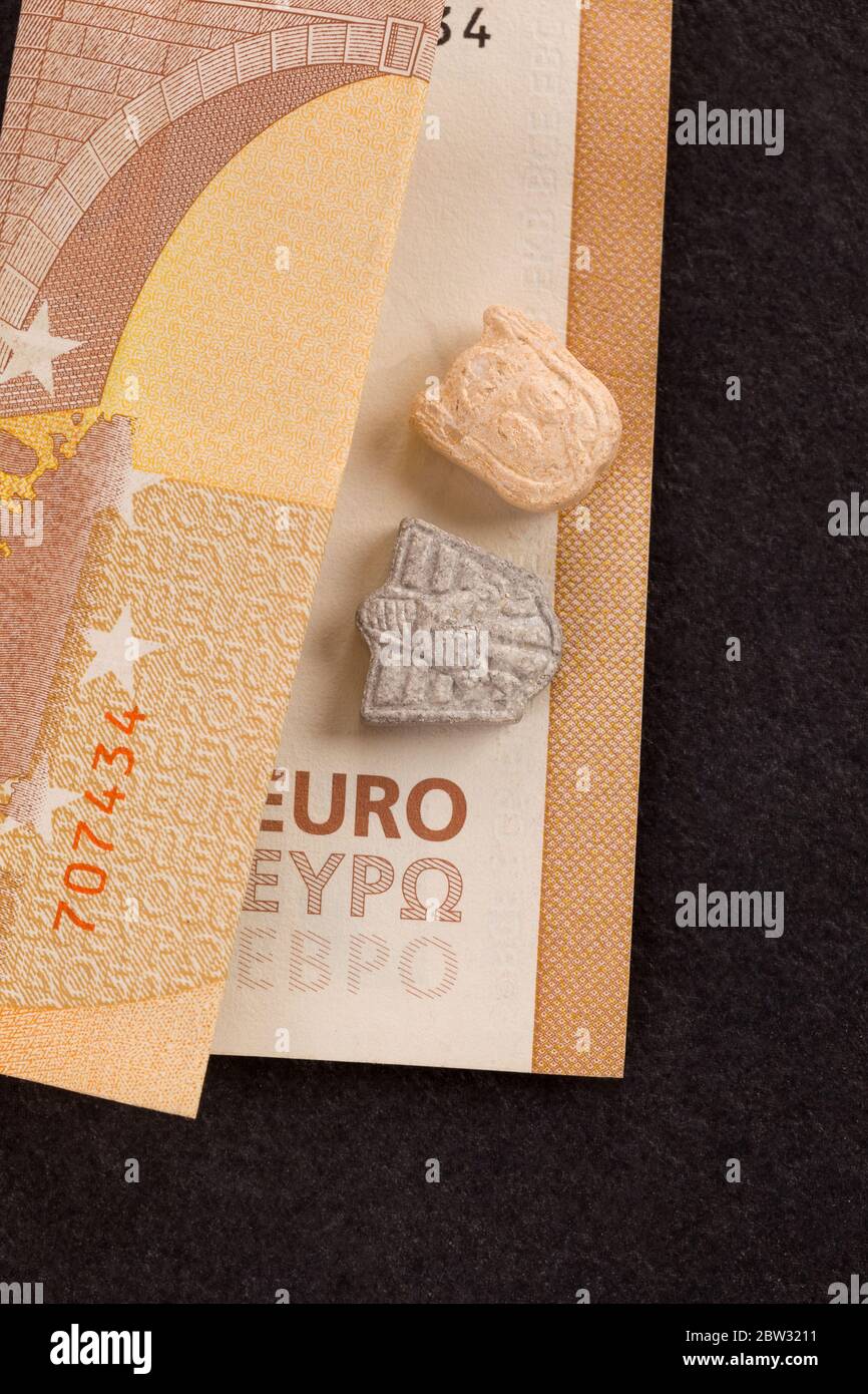Ecstasy pills on euro bill, top view. Dealing drugs. Stock Photo