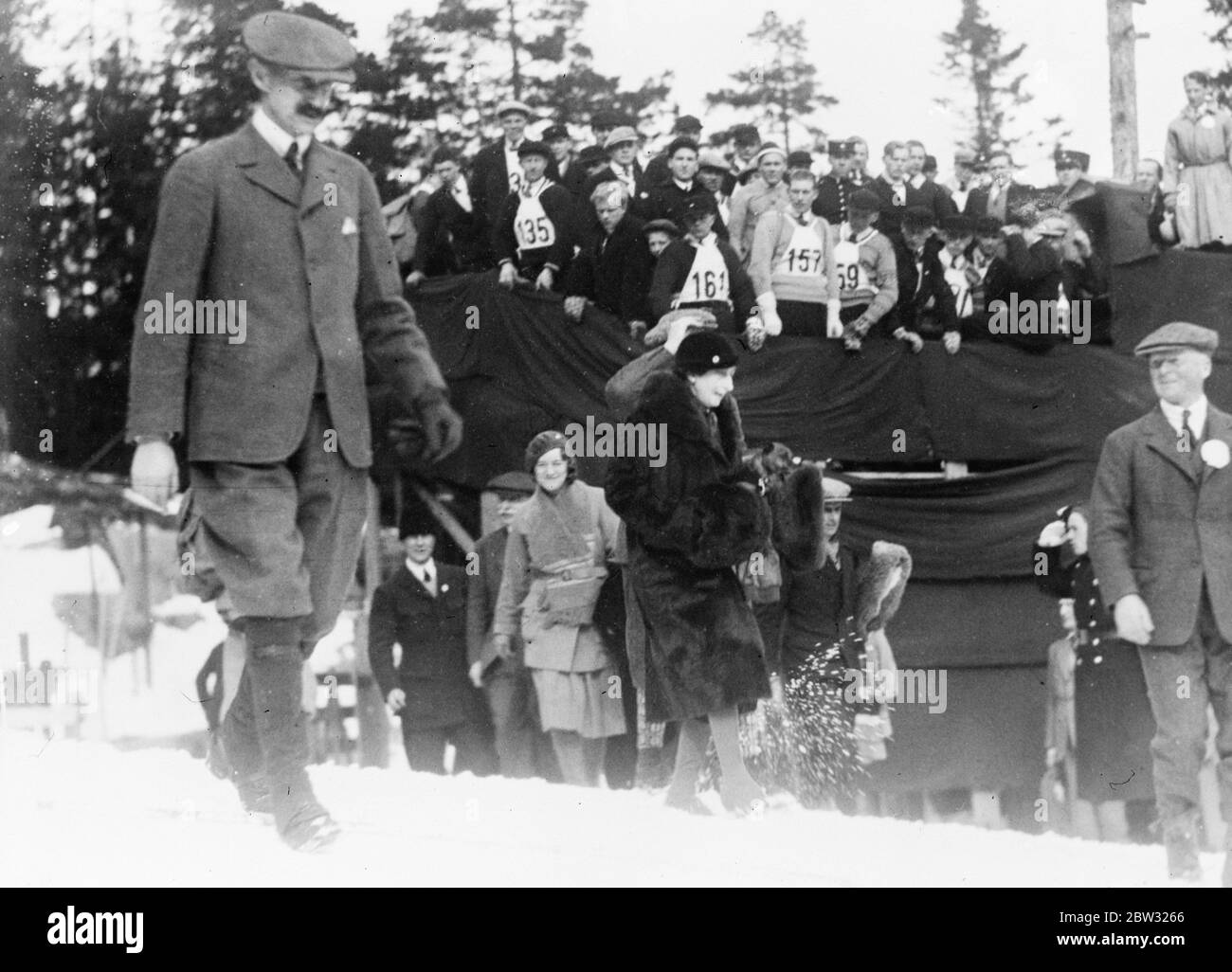 King and Queen of Norway at intenational ski contest . The King and Queen of Norway attended the international ski contests at Holmenkollen , Norway . The King and Queen at Holmenkollen to watch the contests. 16 March 1932 Stock Photo