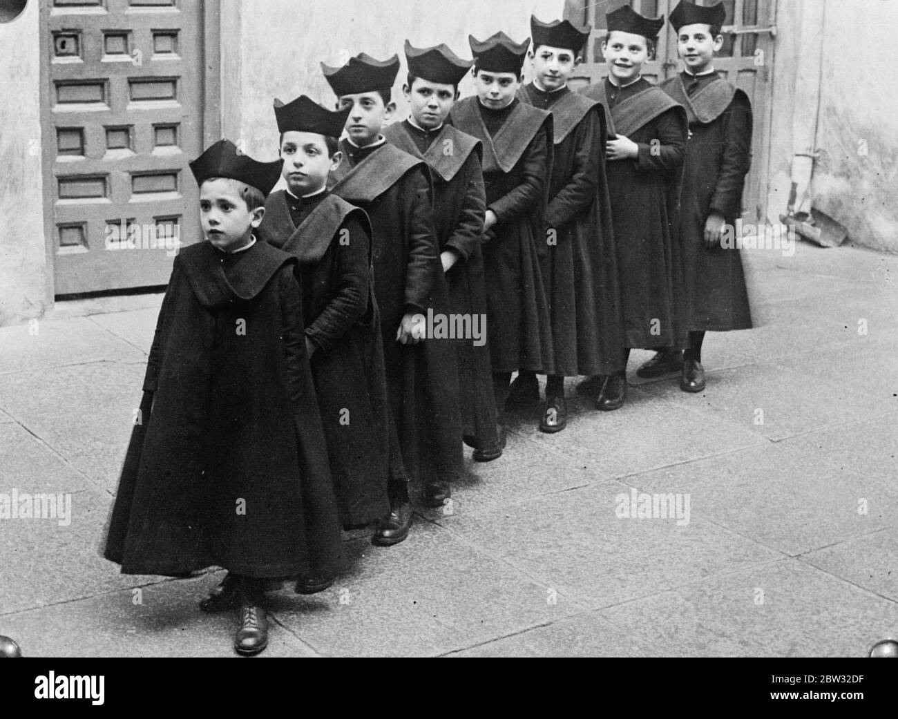 As in ancient days , choirboys of Toledo cathedral . Since the earliest days of ancient Toledo cathedral , there has been a choir of small boys to sing on special days at the cathedral ceremonies . These boys , who originally numbered six , are now eight in number , but they are still known as ' seises ' or ' sixes ' , they still wear the gown and queer crowd like cap which was their priginal dress . Photo shows , the Toledo Cathedral ' Seises ' in their quaint caps and gowns . 23 January 1932 Stock Photo