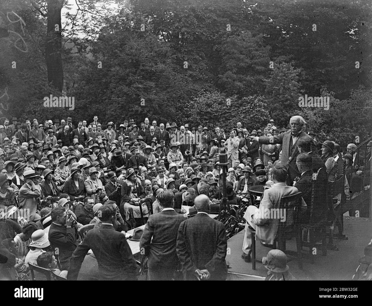 Lloyd George addresses Young Liberals at garden party in his London home . Mr Lloyd George addressed a large gathering of Young Liberals from the home counties at a garden party at his home at Addison Road , Kensington . Mr Lloyd George addressing the gathering at the party . 25 June 1932 Stock Photo