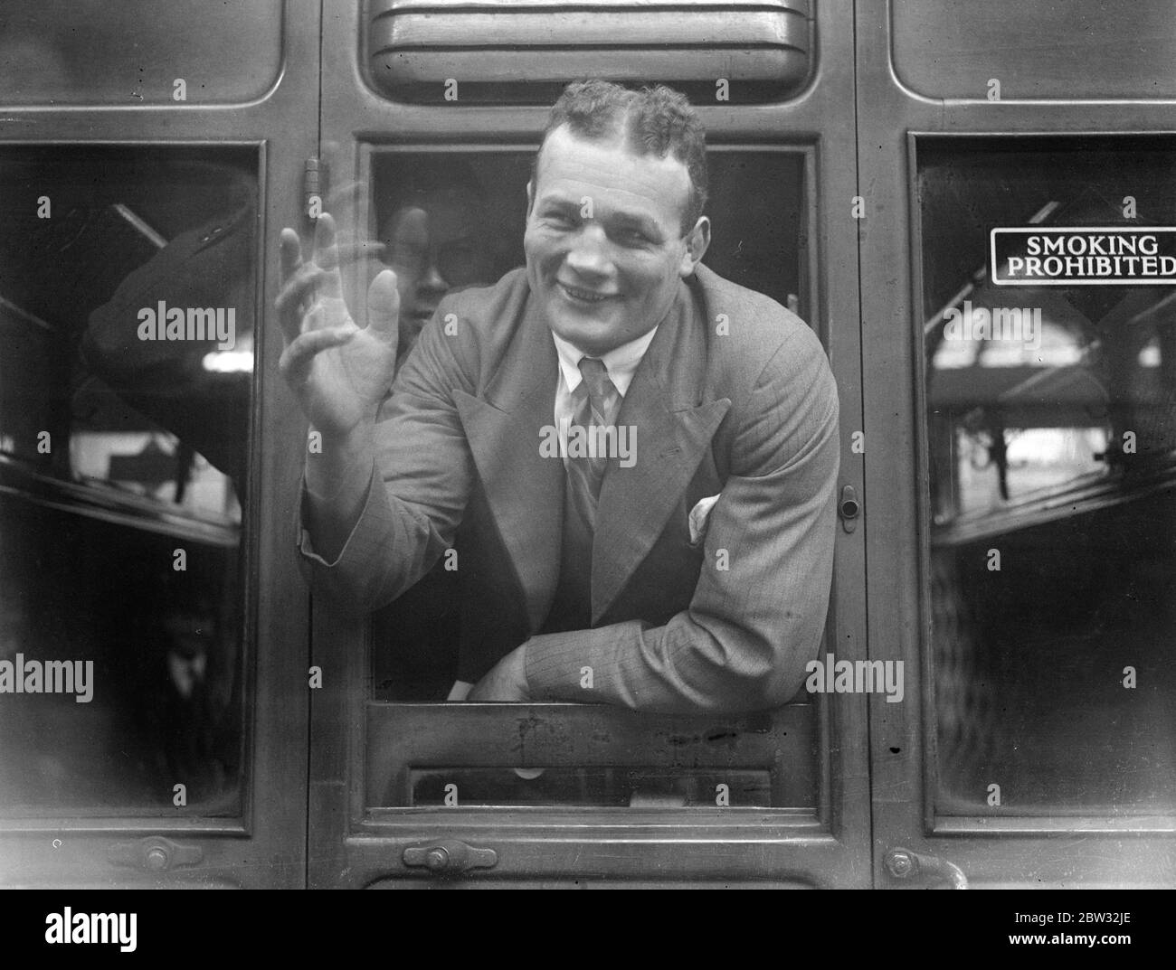 Reggie Meen leaves for Egypt for Championship fight . Reggie Meen the heavyweight boxing champion of Britain left England on the S S Ballarat for Egypt to fight Salar ed Din , the Egyptian Champion in Cairo . Reggie Meen at the window of his carriage as he left Liverpool St Station , London . 15 April 1932 . Stock Photo