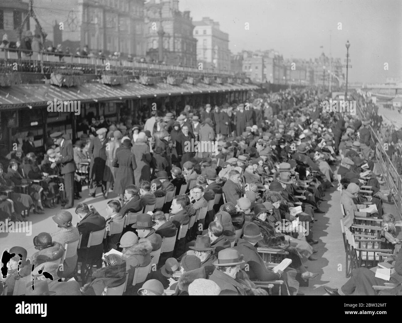 Holiday beach loungers at Eastbourne . So warm has been the weather on the south coast that visitors have been enjoying the sunshine and sea breezes lounging on the beach . The scene on the beach at Eastbourne in the sunny weather .27 March 1932 Stock Photo